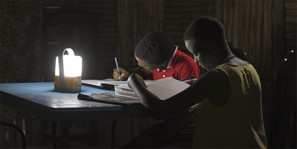two children studying while using the Family Sunshine solar lamp